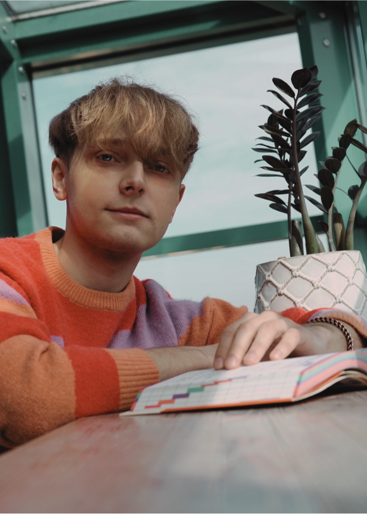 man sitting with book on table
